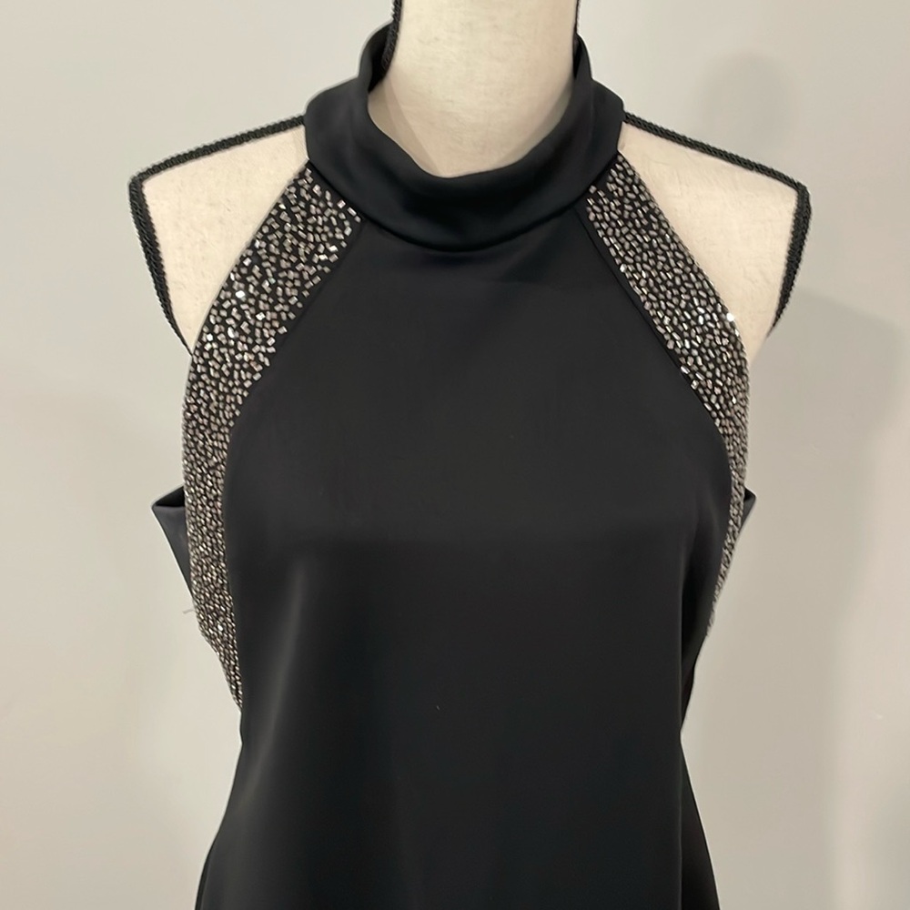 Size 14 black dress with silver accent shoulder. Flattering cut to neck